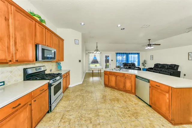 a large kitchen with stainless steel appliances lots of counter space