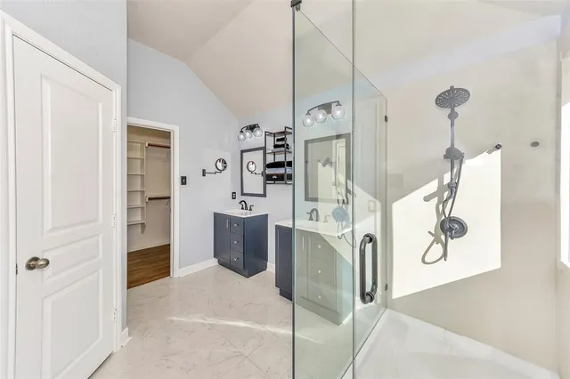 a bathroom with a double vanity sink and a mirror