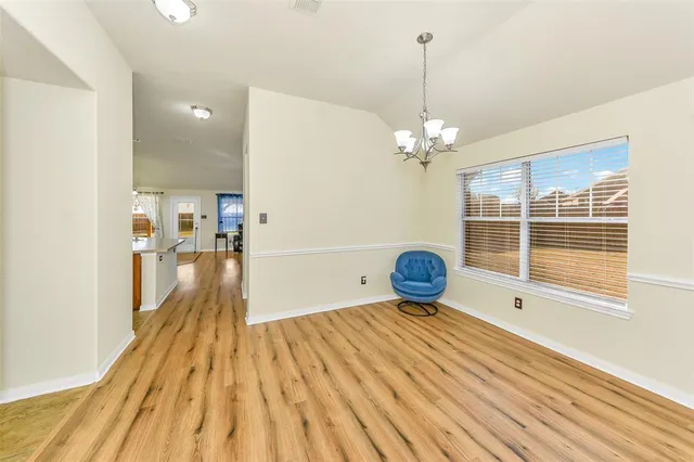 a view of a room with wooden floor and fan
