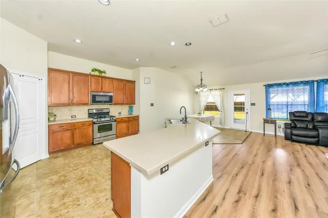 a large kitchen with a large counter top appliances and cabinets
