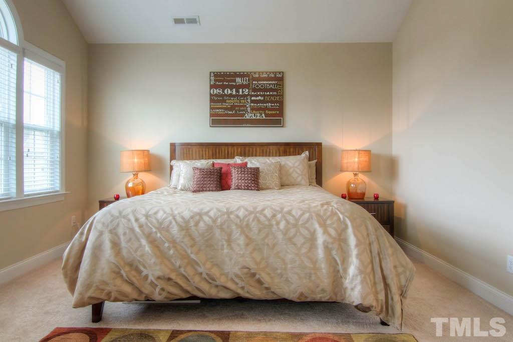 605 Democracy Street Raleigh, NC 27603 - Photo 11 of 25 a bedroom with a bed and window