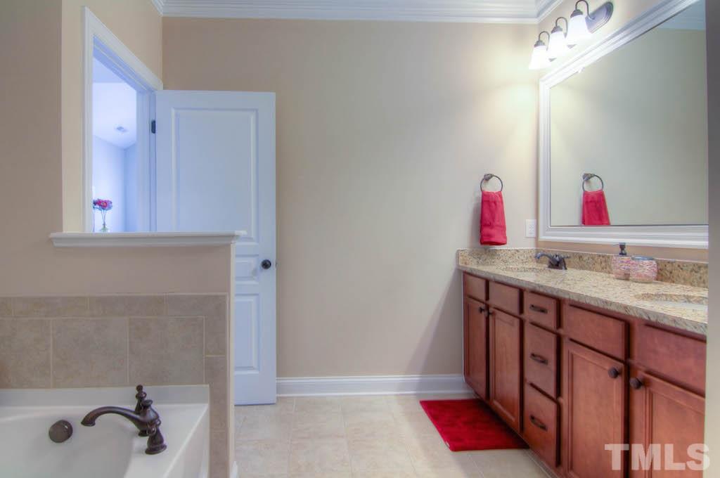 605 Democracy Street Raleigh, NC 27603 - Photo 14 of 25 a bathroom with a sink and a mirror