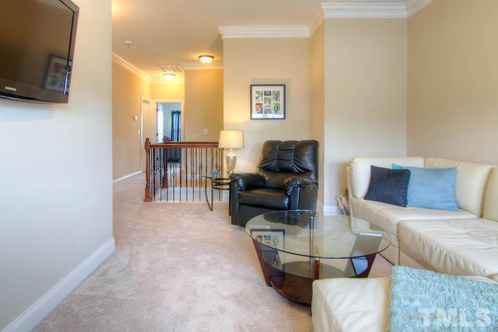 605 Democracy Street Raleigh, NC 27603 - Photo 20 of 25 a living room with furniture and a flat screen tv