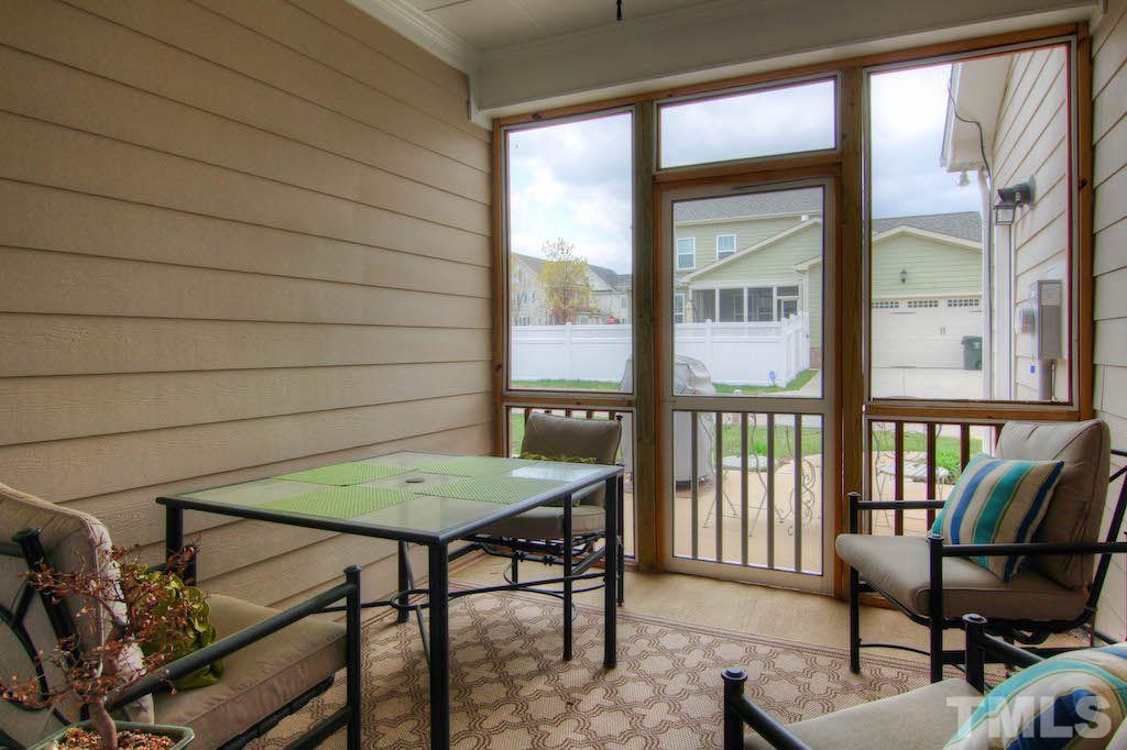 605 Democracy Street Raleigh, NC 27603 - Photo 21 of 25 a view of a balcony dining area with furniture and floor to ceiling window
