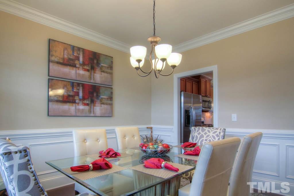 605 Democracy Street Raleigh, NC 27603 - Photo 5 of 25 a view of a dining room with furniture and chandelier