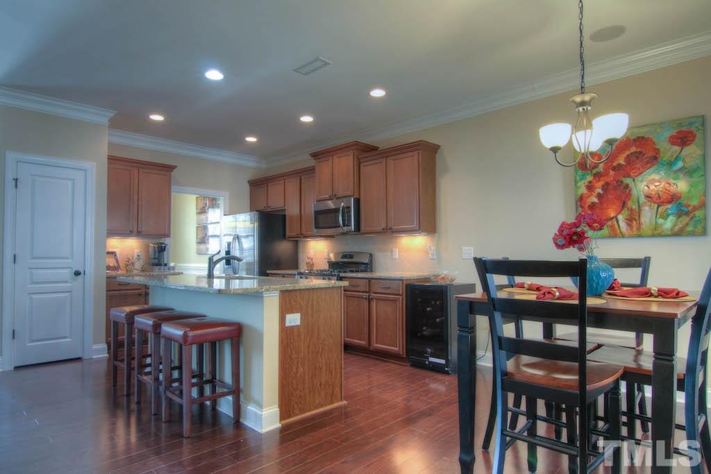 605 Democracy Street Raleigh, NC 27603 - Photo 7 of 25 a kitchen with cabinets and wooden floor