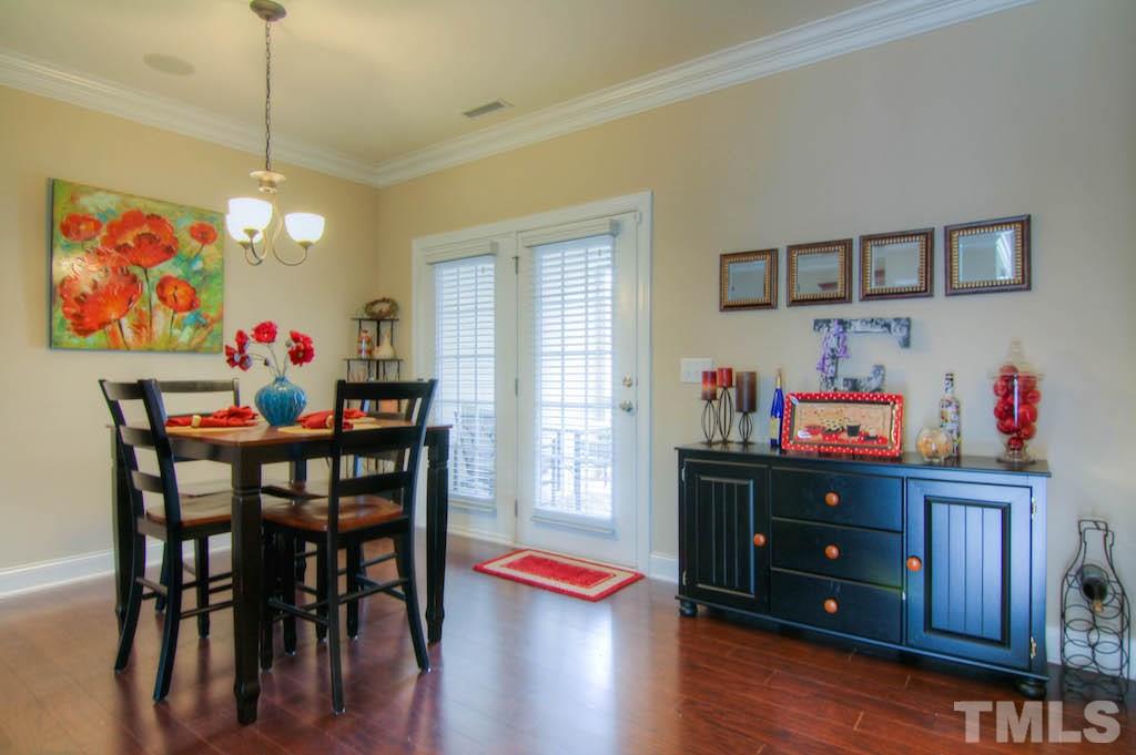 605 Democracy Street Raleigh, NC 27603 - Photo 8 of 25 a view of a dining room with furniture and wooden floor