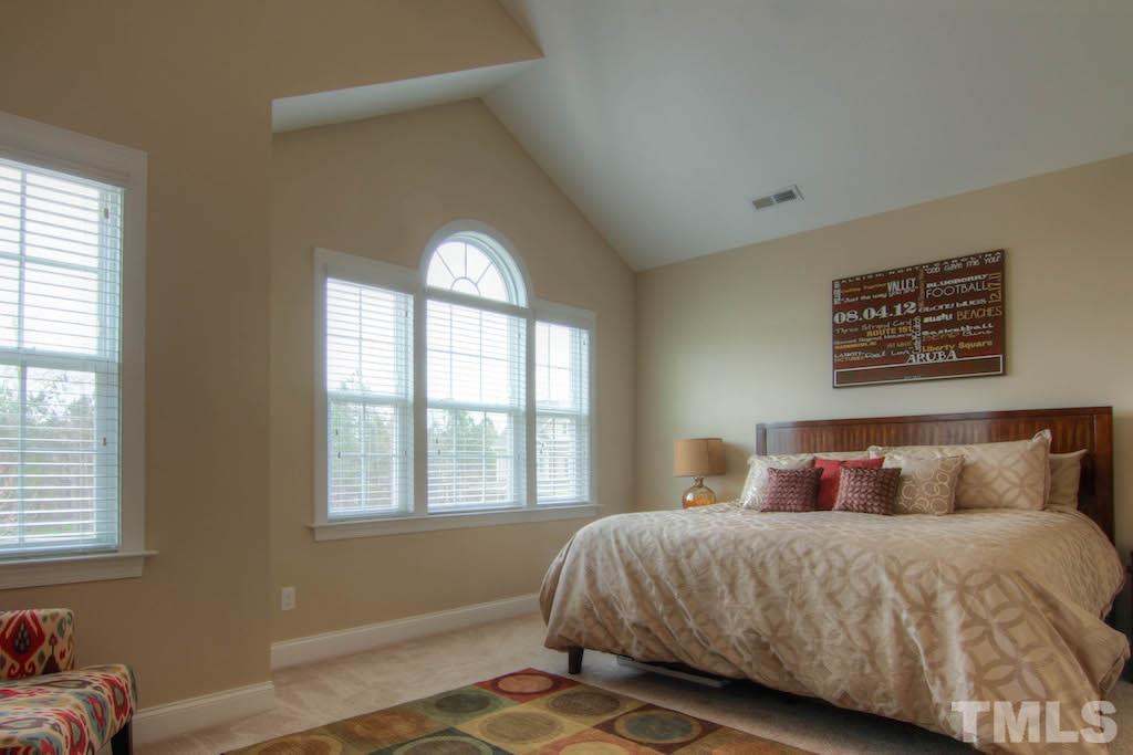 605 Democracy Street Raleigh, NC 27603 - Photo 10 of 25 a bedroom with a bed and a window