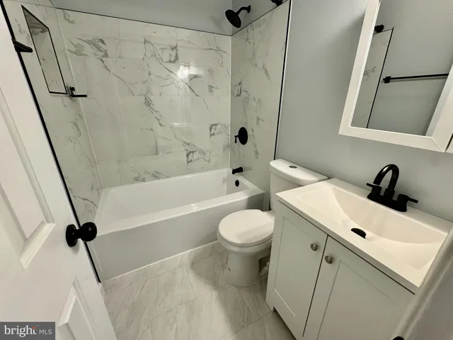 a bathroom with a sink a toilet and a bathtub