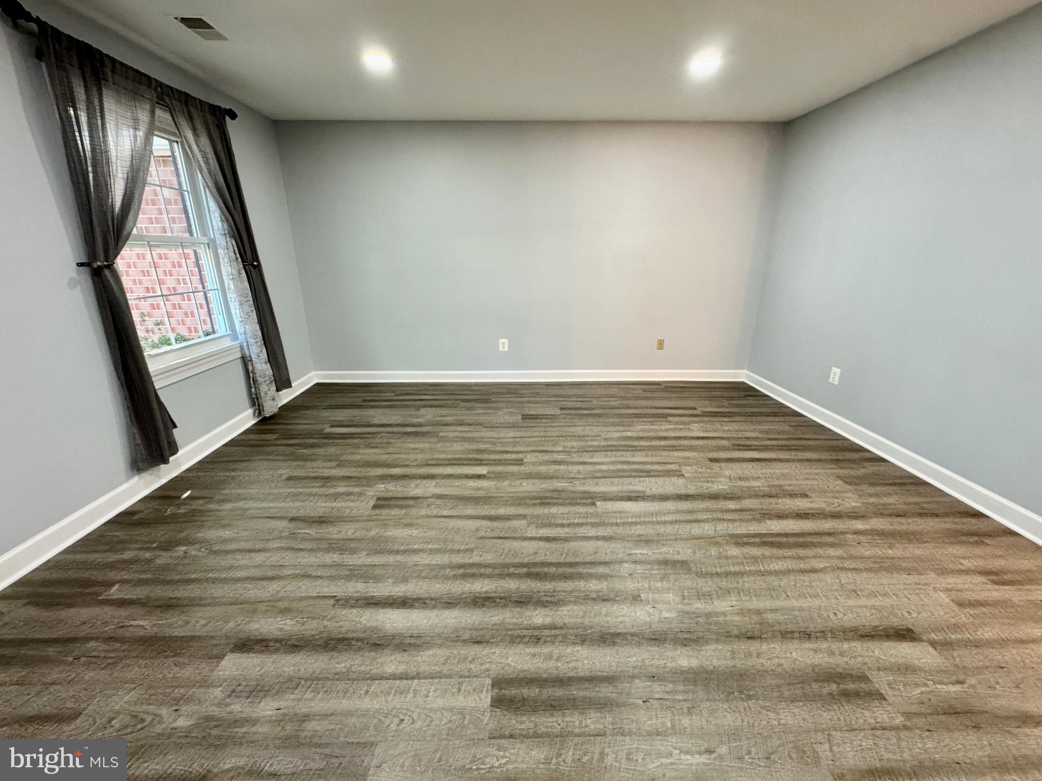 3664 Tavern Way Triangle, VA 22172 - Photo 7 of 28 a view of empty room with window and wooden floor
