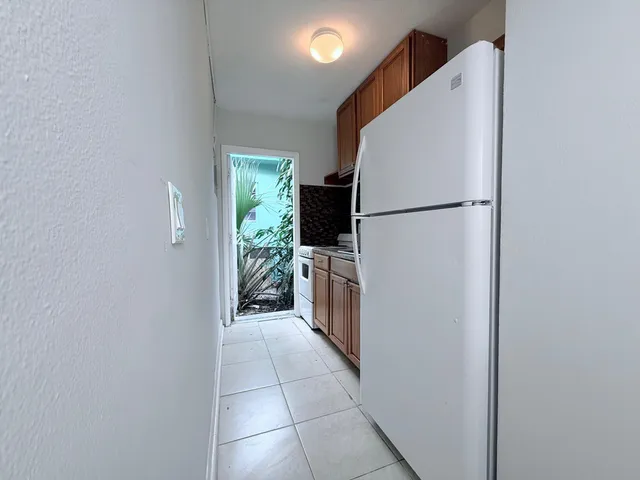 a kitchen with a refrigerator and a stove