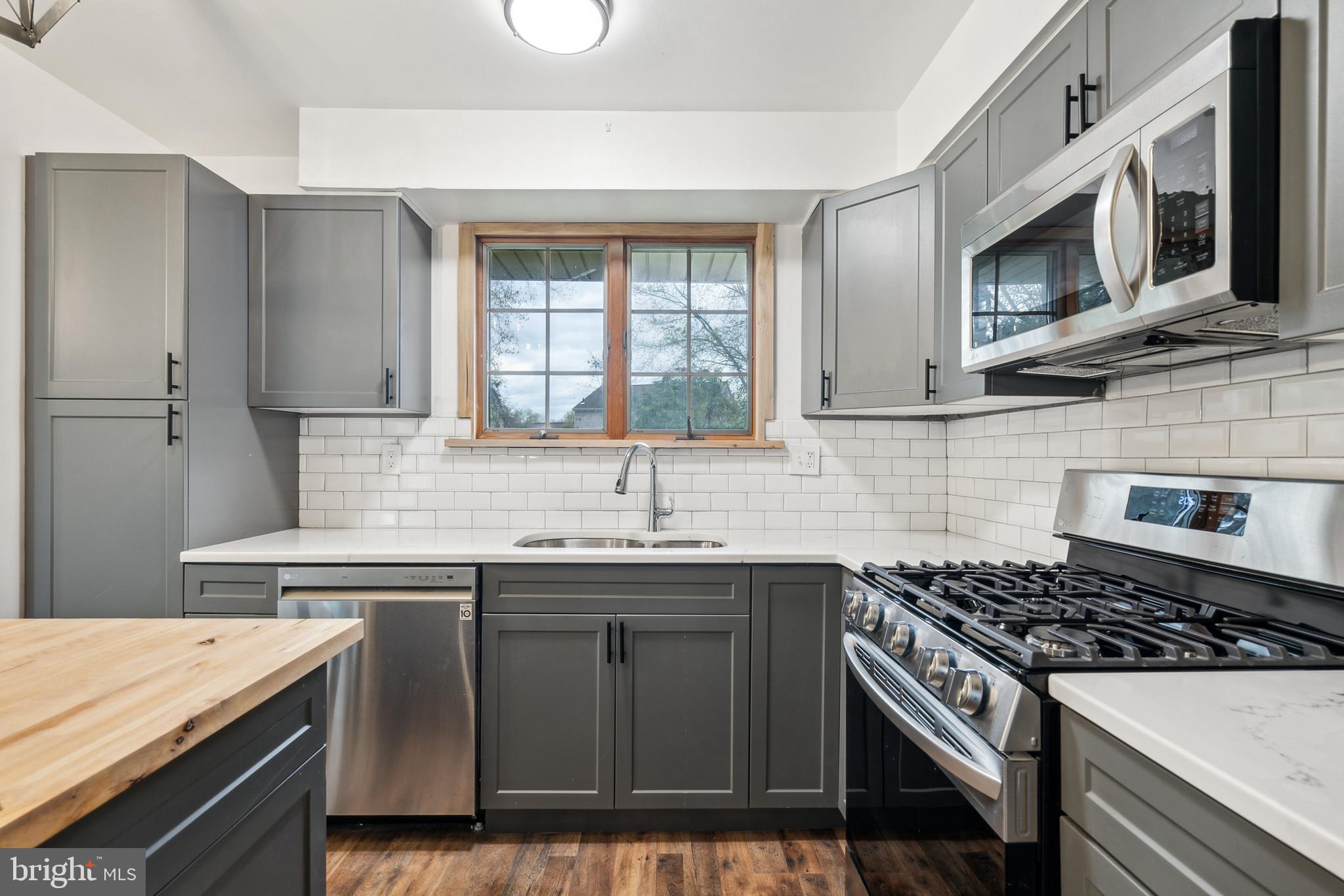 306 Colonial Road Edgewater Park, NJ 08010 - Photo 12 of 25 a kitchen with stainless steel appliances a sink stove and microwave