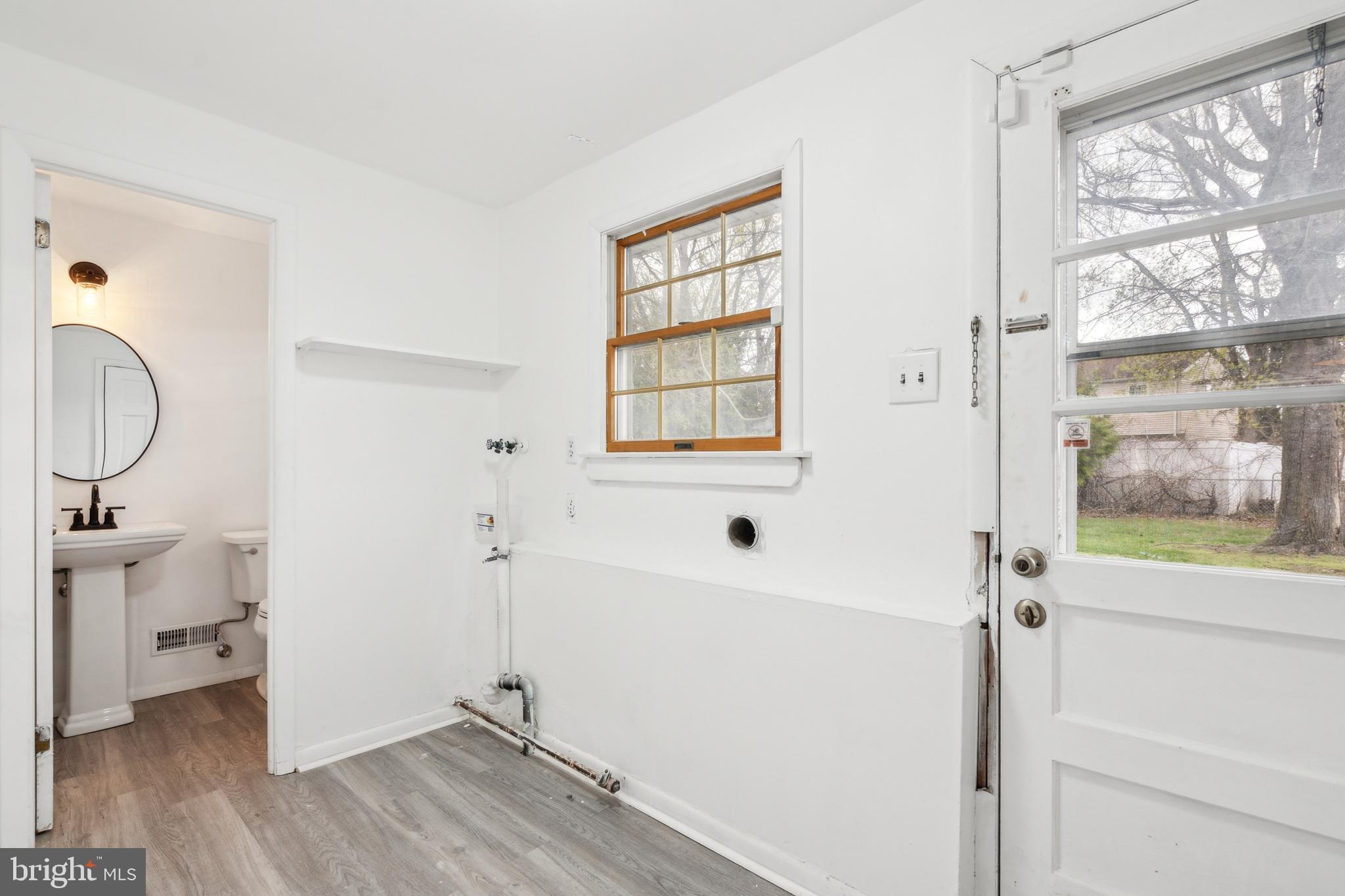 306 Colonial Road Edgewater Park, NJ 08010 - Photo 13 of 25 a view of bathroom with bathtub window and wooden floor
