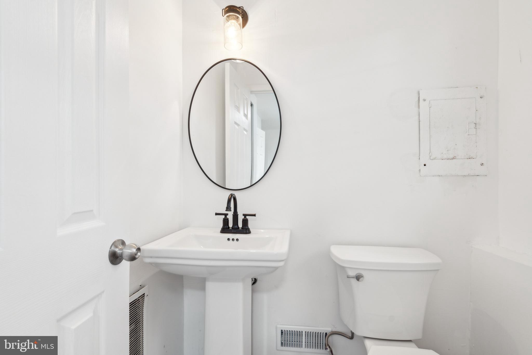306 Colonial Road Edgewater Park, NJ 08010 - Photo 14 of 25 a bathroom with a toilet a sink and mirror