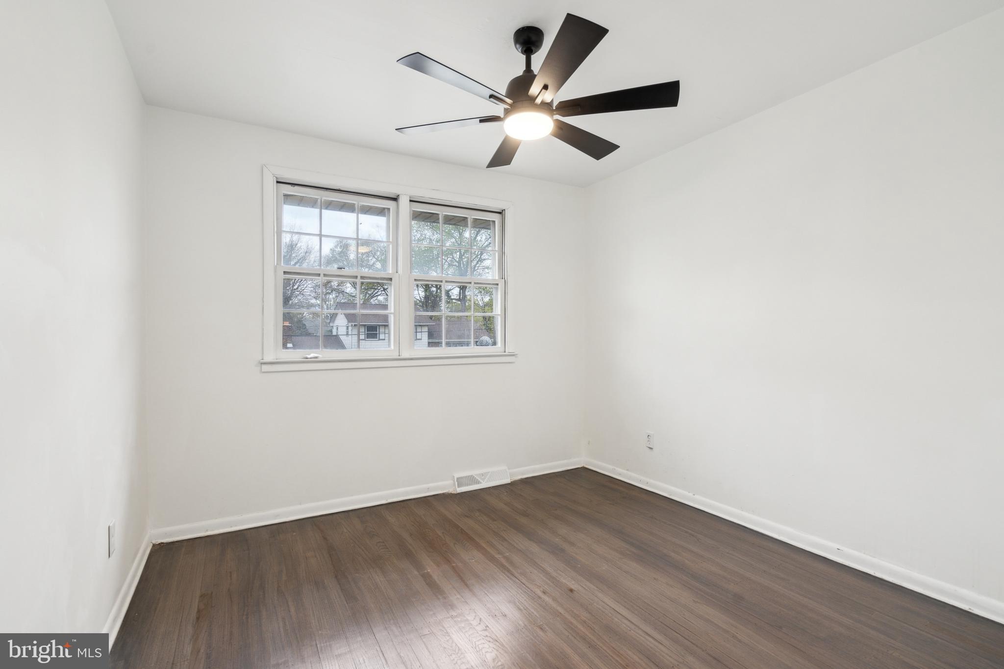306 Colonial Road Edgewater Park, NJ 08010 - Photo 15 of 25 an empty room with wooden floor and windows