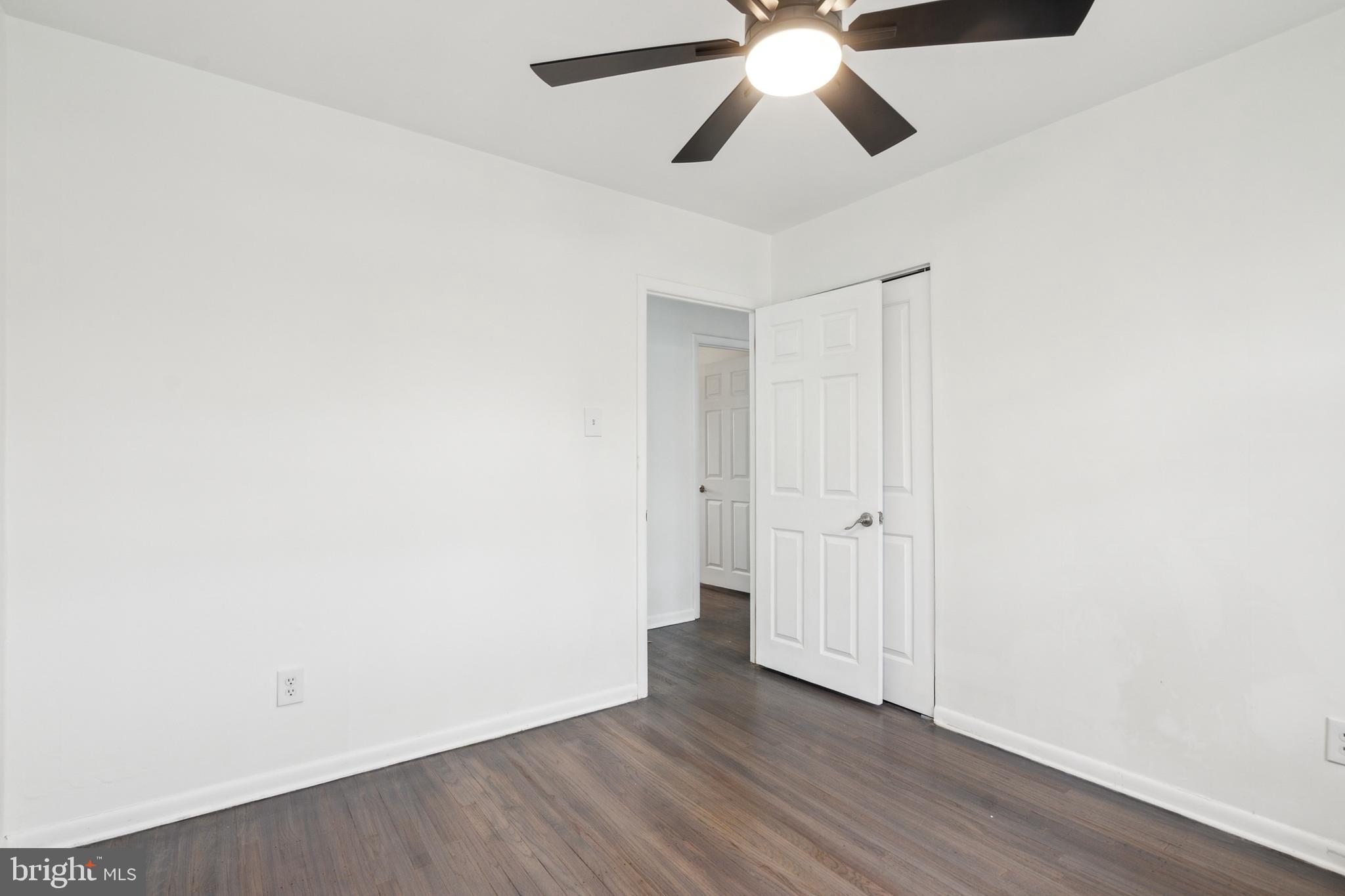 306 Colonial Road Edgewater Park, NJ 08010 - Photo 16 of 25 an empty room with wooden floor chandelier fan and closet