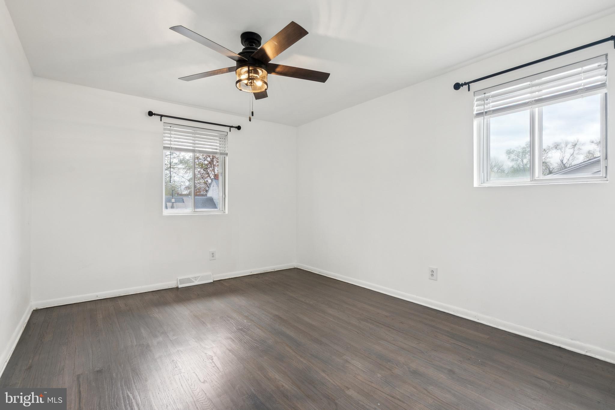 306 Colonial Road Edgewater Park, NJ 08010 - Photo 19 of 25 a view of empty room with wooden floor and fan