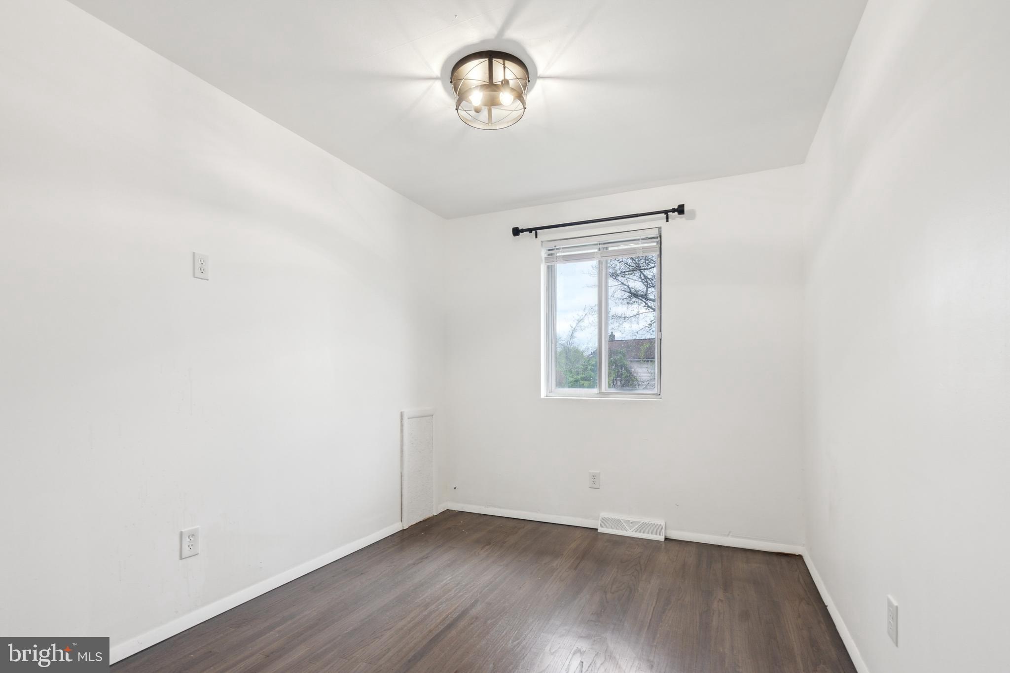 306 Colonial Road Edgewater Park, NJ 08010 - Photo 21 of 25 an empty room with wooden floor table and windows