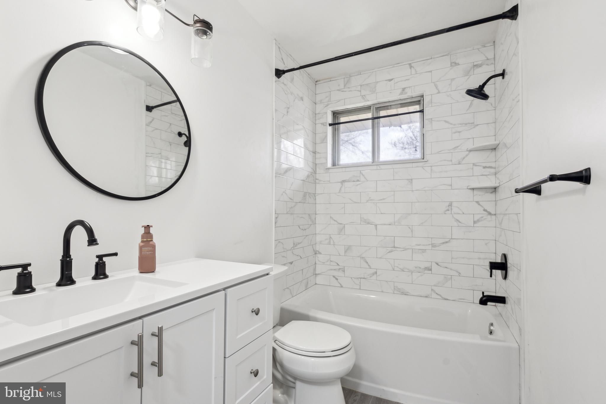 306 Colonial Road Edgewater Park, NJ 08010 - Photo 23 of 25 a bathroom with a sink a toilet and a mirror