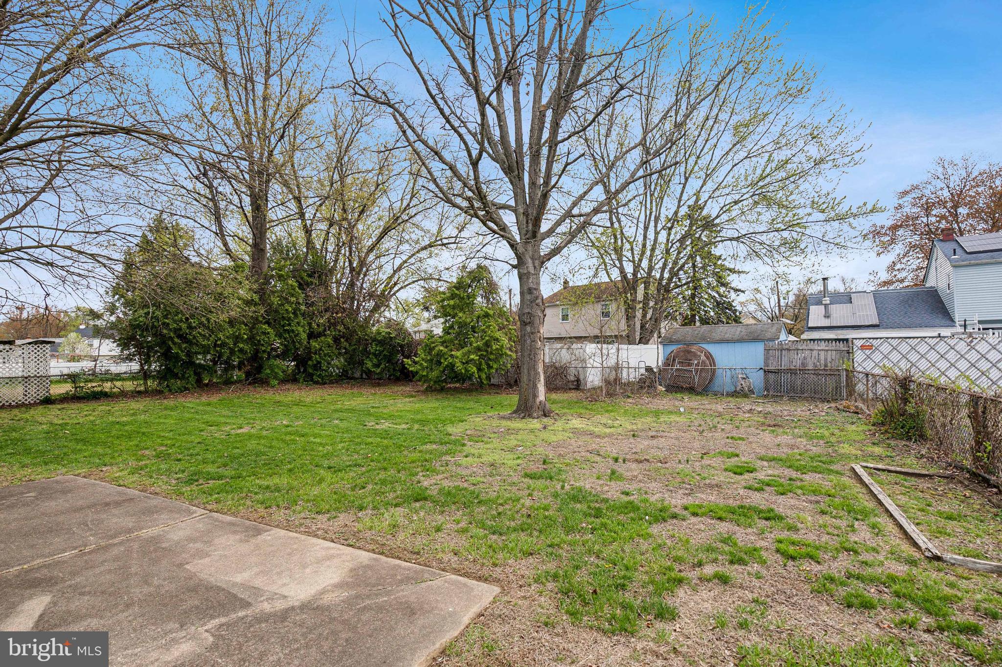 306 Colonial Road Edgewater Park, NJ 08010 - Photo 24 of 25 a view of a yard with a house and large trees