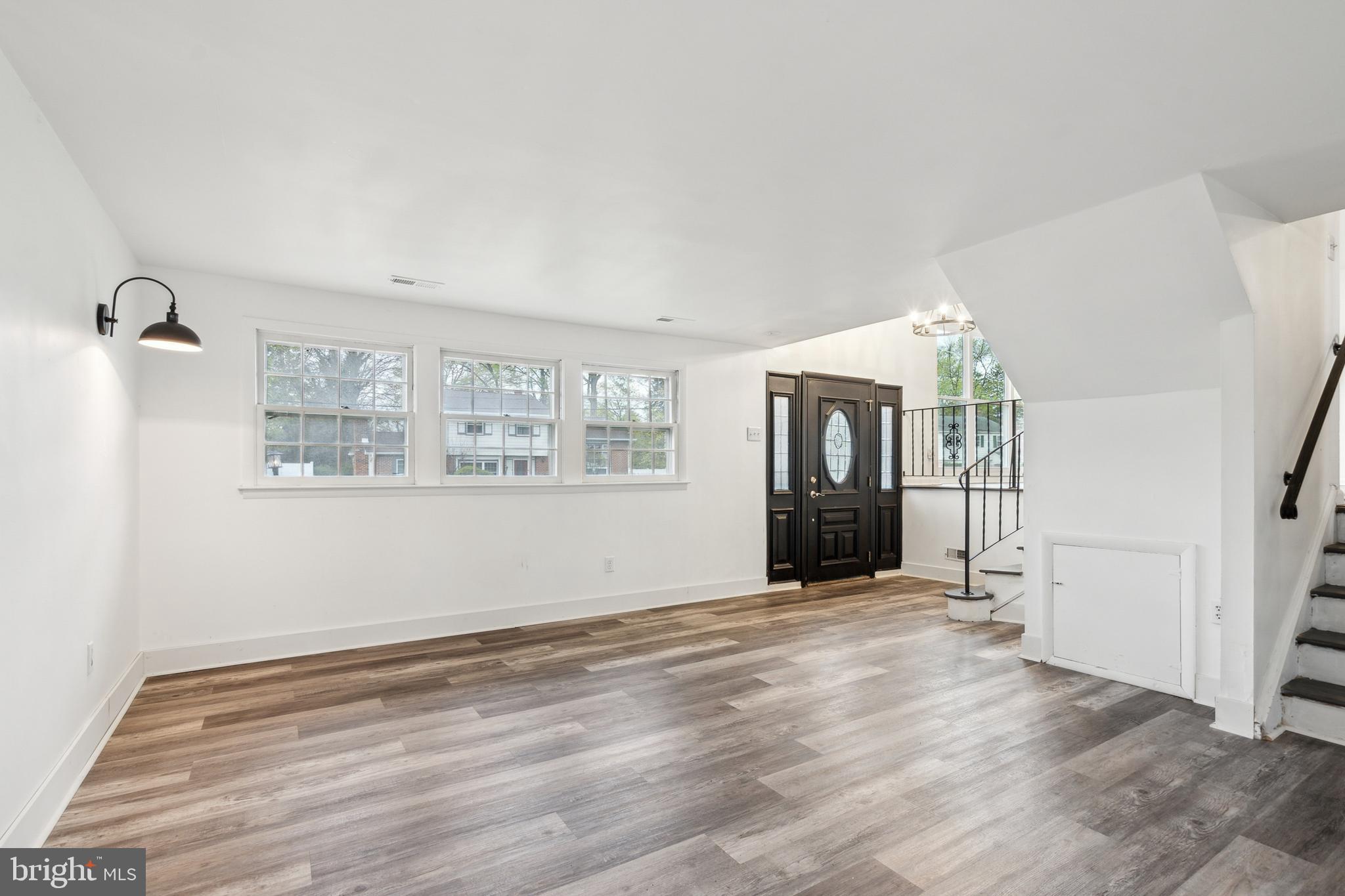 306 Colonial Road Edgewater Park, NJ 08010 - Photo 5 of 25 a view of an empty room with wooden floor and a window