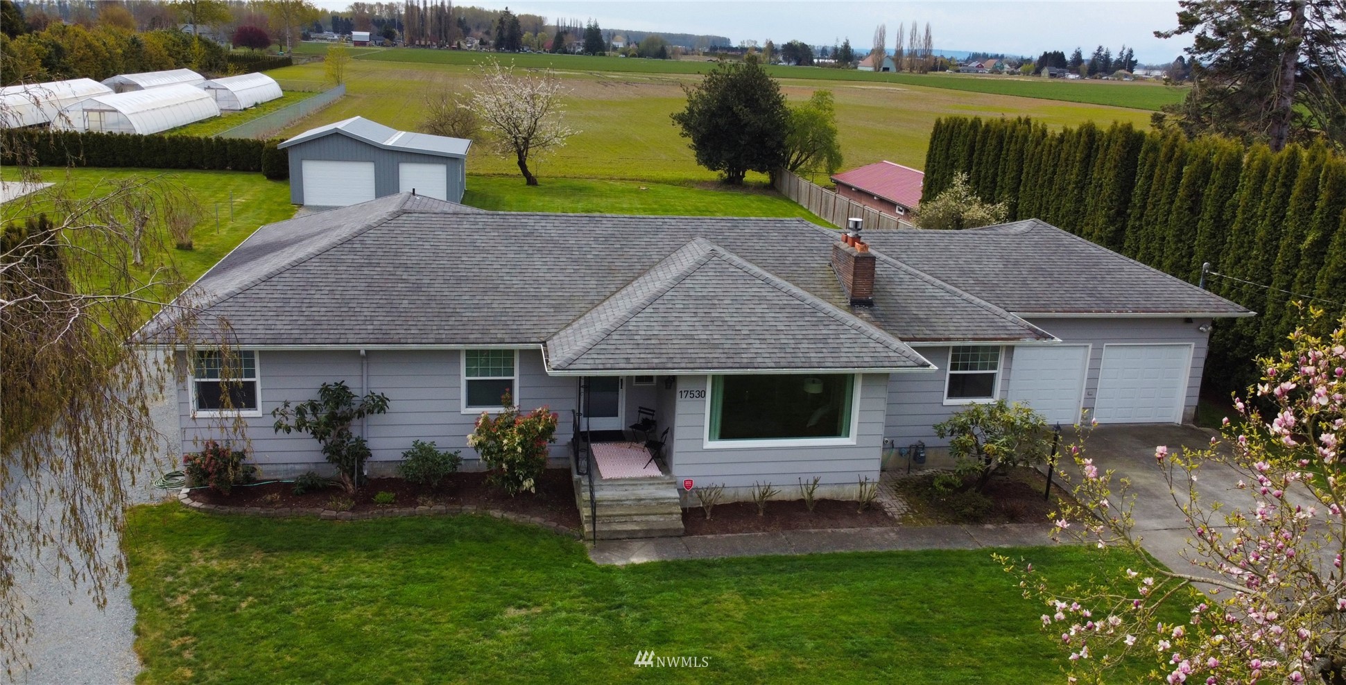 17530 Dunbar Road Mount Vernon, WA 98273 - Photo 1 of 40 a aerial view of a house with table and chairs potted plants and large tree