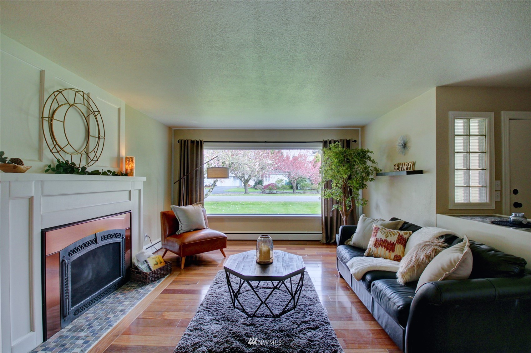 17530 Dunbar Road Mount Vernon, WA 98273 - Photo 6 of 40 a living room with furniture a flat screen tv and a fireplace