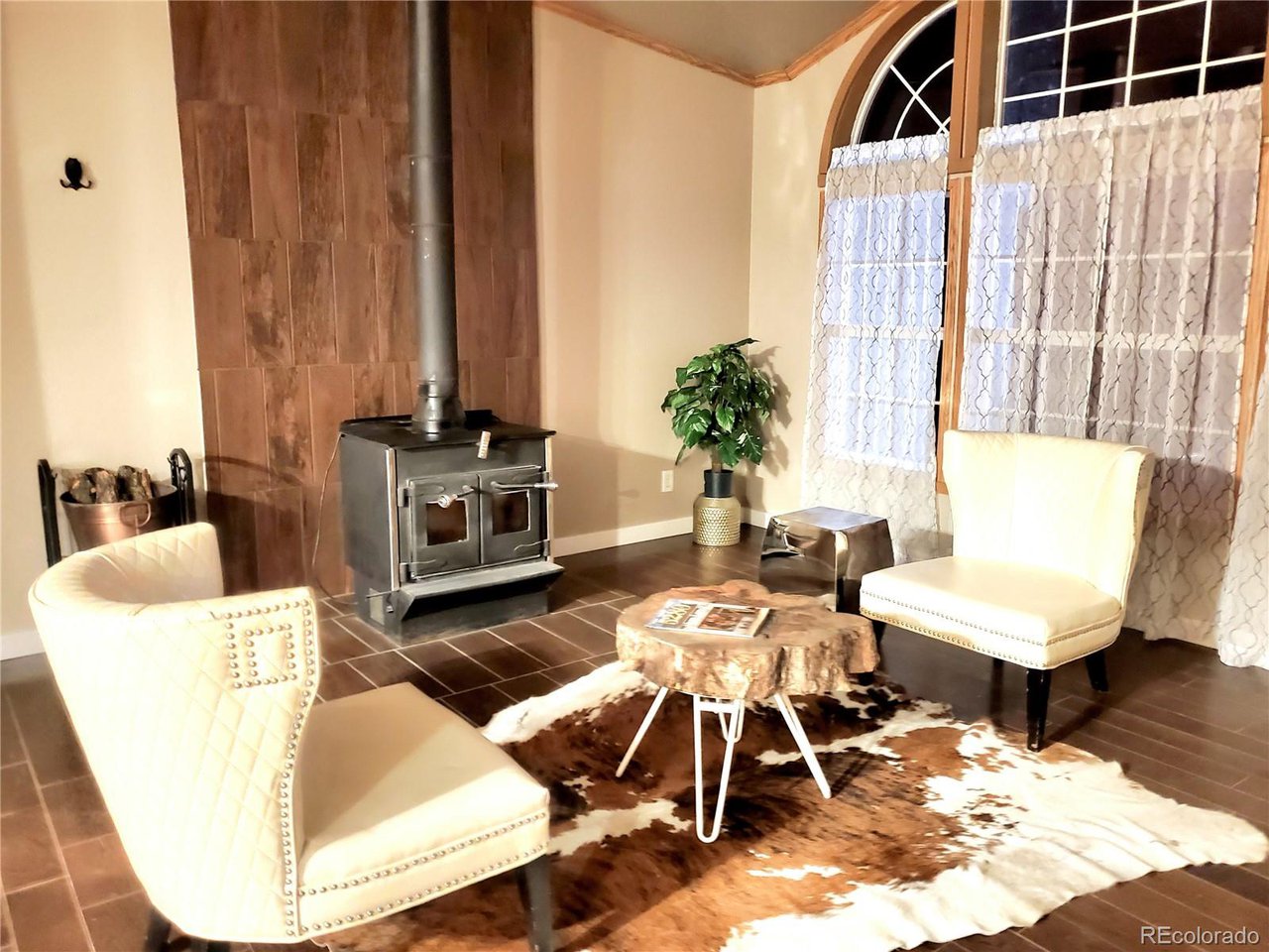 5339 County Road 19 Florence, CO 81226 - Photo 12 of 50 Entry living room with wood stove and beautiful cathedral windows