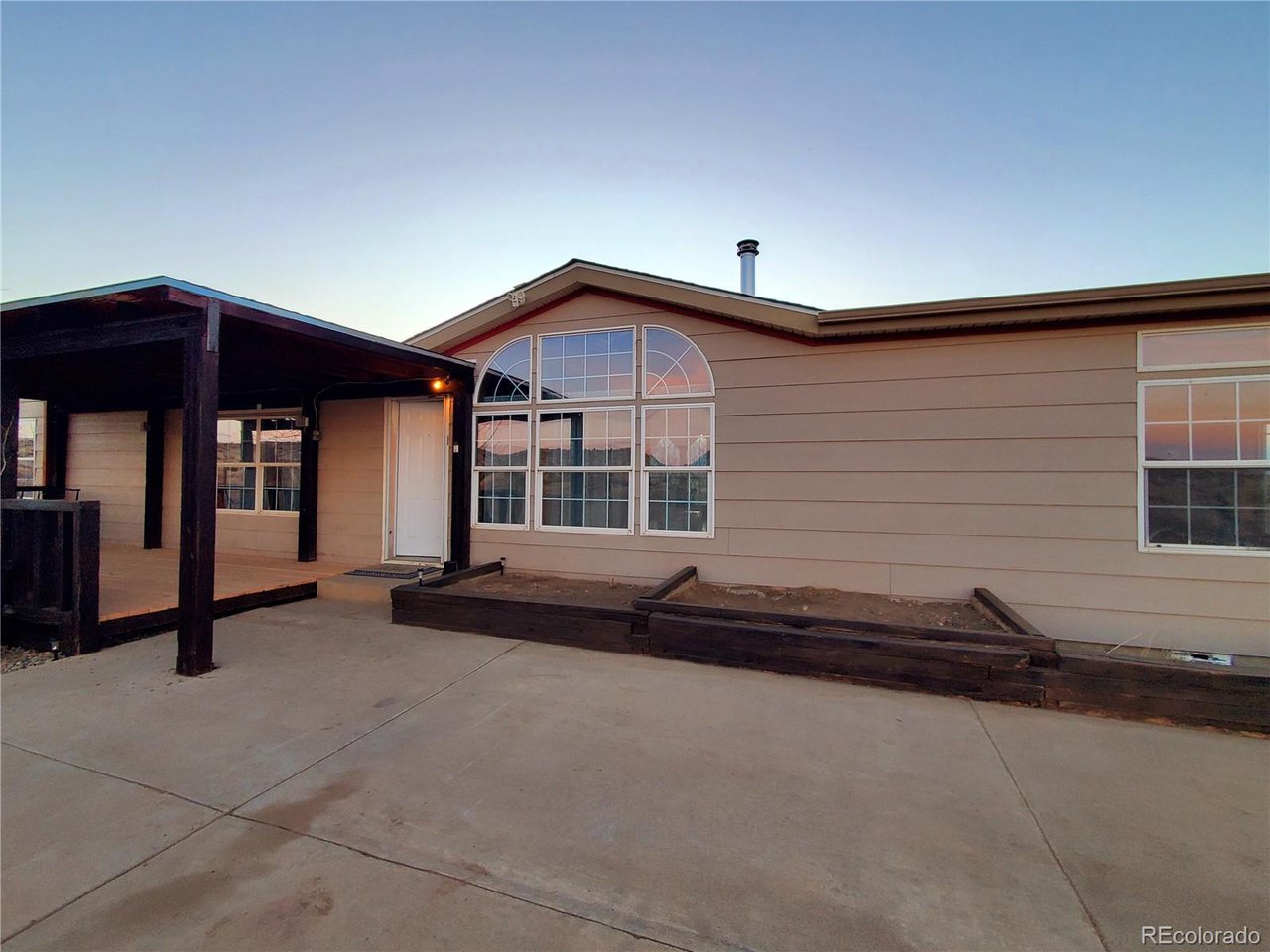 5339 County Road 19 Florence, CO 81226 - Photo 7 of 50 entry with new covered porch wood decking, raised garden beds
