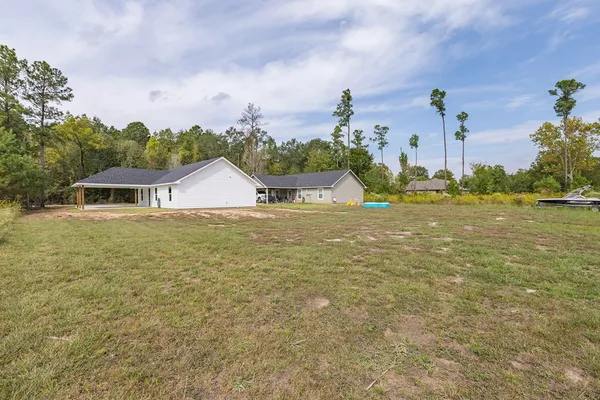 a view of a house with a yard and a garage
