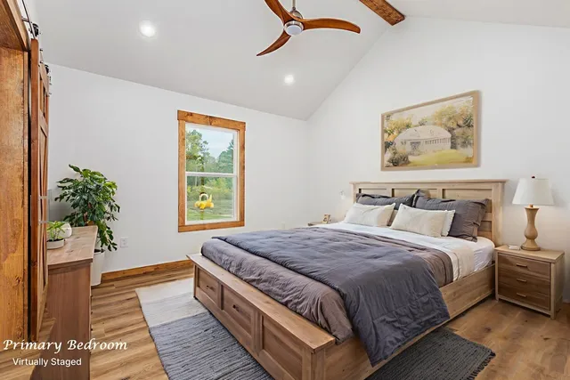 a bedroom with bed and window