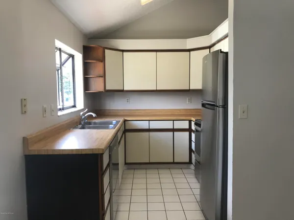 a kitchen with a sink a stove and cabinets
