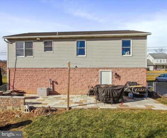 a backyard of a house with table and chairs