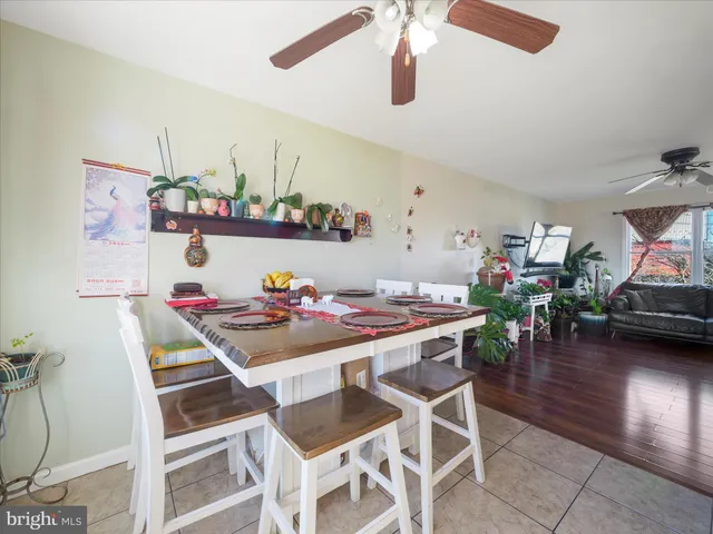 a view of a dining room with furniture and a chandelier