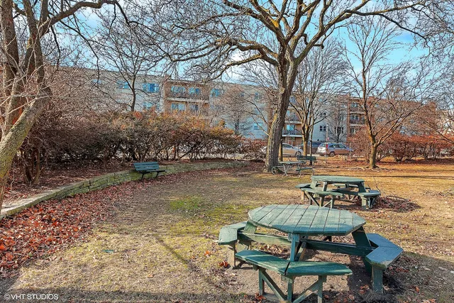 a view of a lake with chairs and table in the patio
