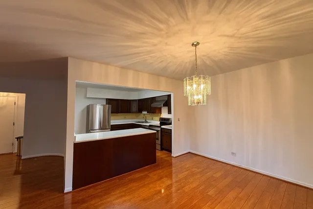 a kitchen with granite countertop a stove and a wooden floors