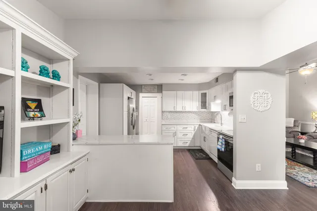a kitchen with a refrigerator sink and cabinets