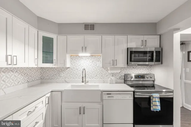a view of kitchen with cabinets