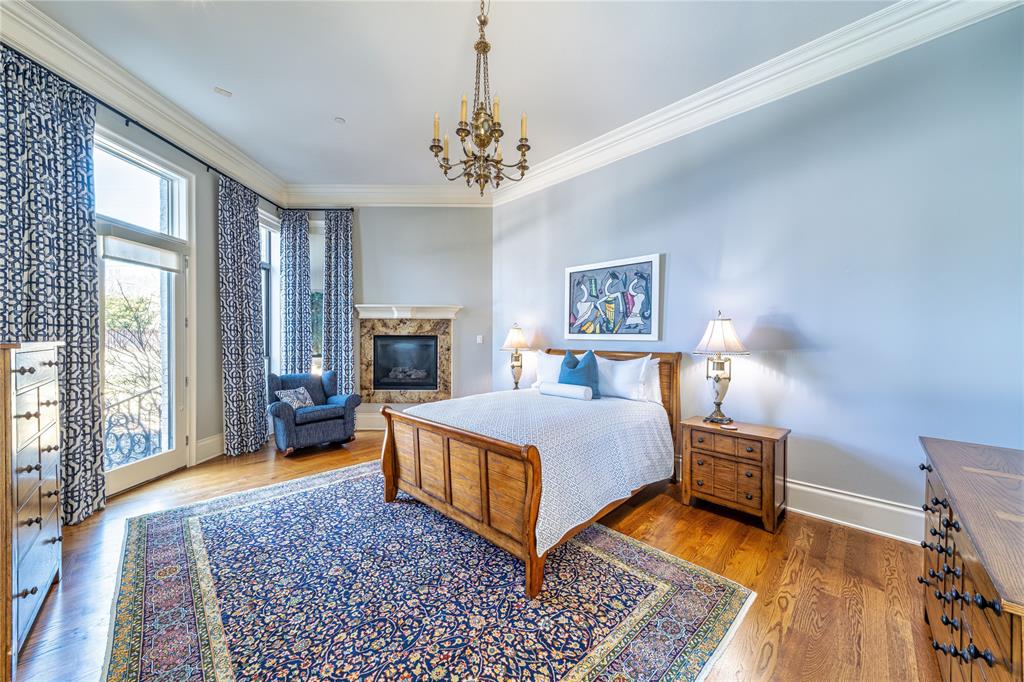 4511 Watauga Road Dallas, TX 75209 - Photo 19 of 40 a spacious bedroom with a bed dresser and a window