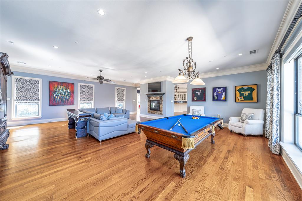 4511 Watauga Road Dallas, TX 75209 - Photo 21 of 40 a living room with furniture a rug and a chandelier