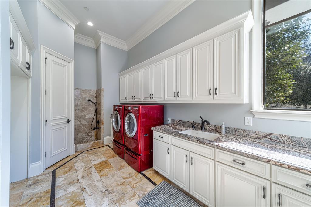 4511 Watauga Road Dallas, TX 75209 - Photo 31 of 40 a utility room with cabinets washer and dryer