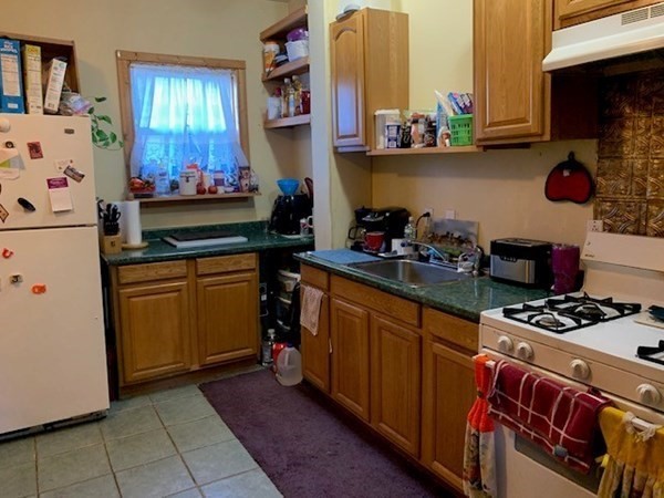 192 Last Street Fall River, MA 02724 - Photo 13 of 33 a kitchen with stainless steel appliances a stove a sink and a refrigerator