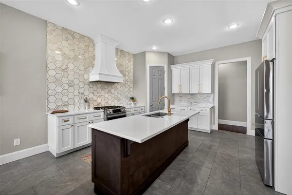 a kitchen with a refrigerator sink and stove