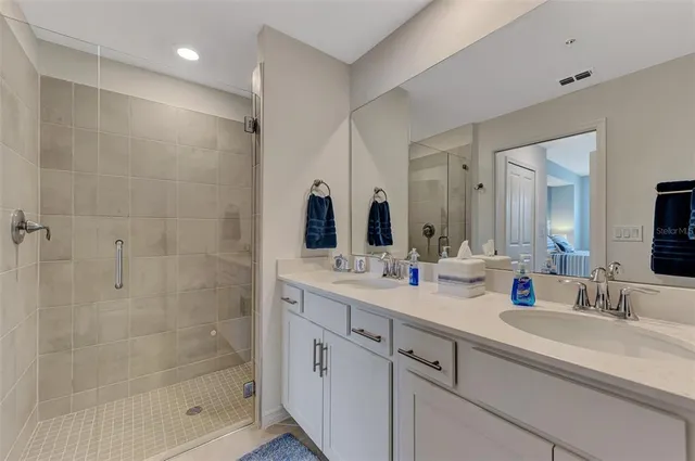a bathroom with double sink and a mirror