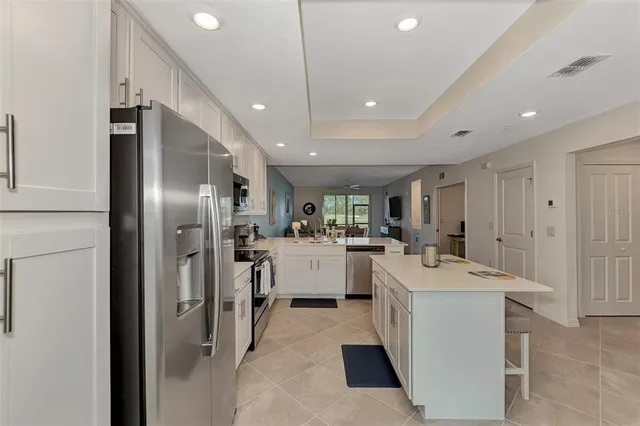 a kitchen with a sink stainless steel appliances and counter space