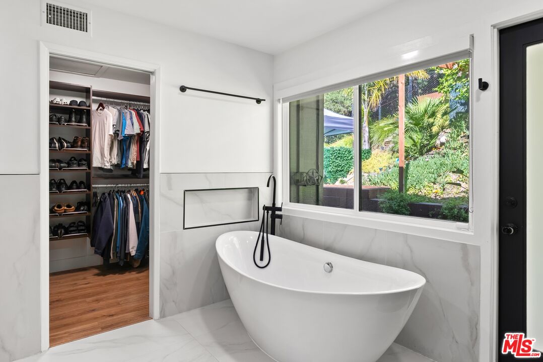 4118 Oak Hollow Road Calabasas, CA 91302 - Photo 41 of 55 a bathroom with a bathtub and a window
