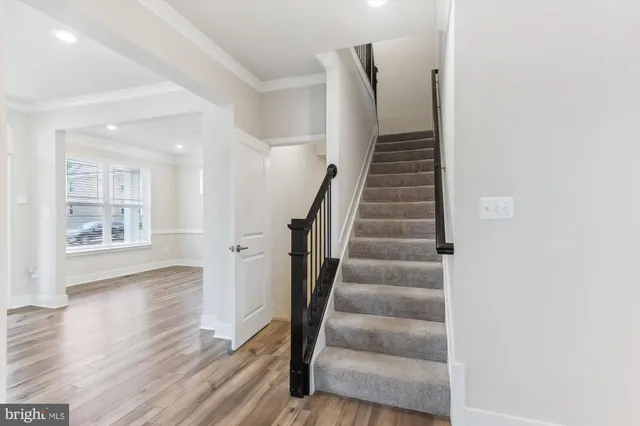 a view of entryway and hall with wooden floor