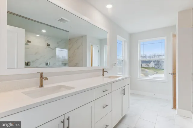 a bathroom with a sink a mirror and a bathtub
