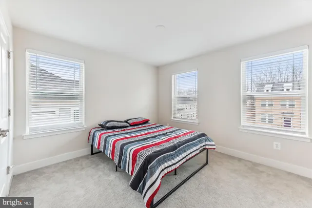 a bed sitting in a bedroom next to a window
