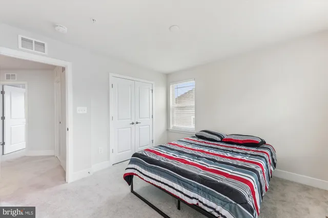 a bedroom with bed and a window